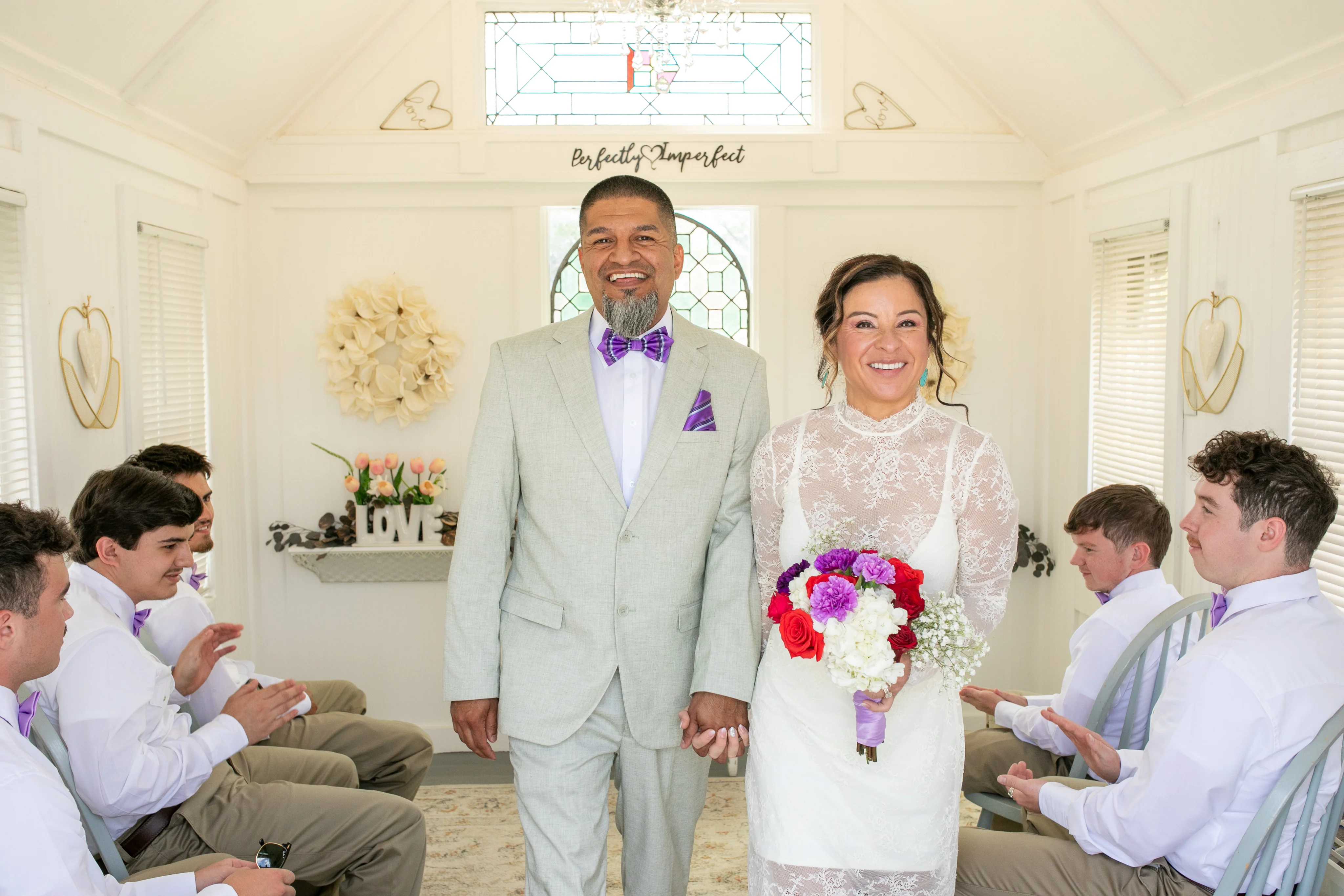 Couple exchanging vows at the little white chapel in Austin